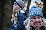 Portrait of girl and her sister in rural landscape wearing knit hat