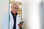 Doctor looking at mobile phone