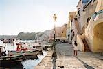 Woman on sidewalk, Island of Procida, Bay of Naples, Campania, Italy