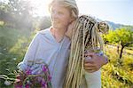 Romantic young couple with wildflowers in field, Majorca, Spain