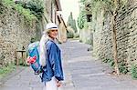 Portrait of stylish mature woman on cobbled street, Fiesole, Tuscany, Italy
