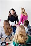 Teenage girl presenting project in front of classmates