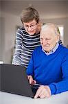 Senior couple using laptop