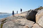 Father and mother walking with child by sea