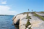 Two children with dog on cliff