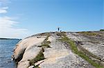 Boy with dog on cliff