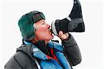 Man drinking from ski boot