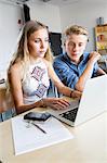 Teenagers with laptop in classroom