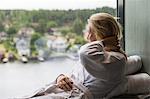 Woman looking through window