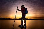 Ice skater on frozen lake