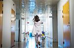 Doctor walking through hospital corridor