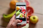 Woman photographing fruits