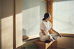 Female doctor sitting by window