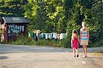 Girls holding hands while walking on road