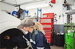 Female mechanic examining a car wheel disc brake