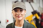Portrait of female mechanic in repair garage