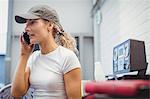 Female mechanic talking on mobile phone