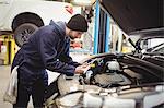 Mechanic using digital tablet on car