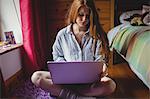 Woman using laptop at home