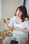 Pregnant woman having salad