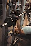 Fit woman exercising with smith machine in the gym