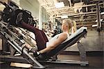 Fit woman exercising on a machine in the gym