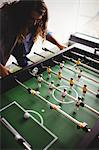 Concentrated man playing table football game