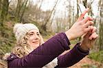 Woman taking selfie in the forest