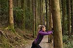 Woman performing stretching exercise in forest