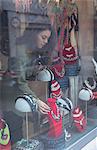 Woman selecting accessories in jewelry section of boutique