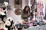 Woman selecting bangles in jewelry section of boutique