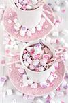 Mug of hot chocolate with marshmallow and heart shaped candies