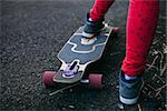 longboard on the road with teenage close up