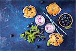 Homemade muffins with blueberries and yogurt with mint. Top view. Selective focus.