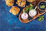 Homemade muffins with blueberries and yogurt with mint. Food background with copy space. Top view. Selective focus.