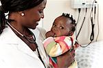 Closeup of an African female doctor holding an infant