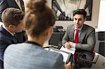 Businessman and women having discussion in boardroom meeting