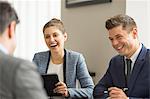 Businessmen and woman having office meeting