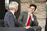 Businessman and woman having meeting on office sofa