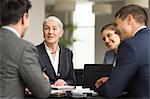 Over shoulder view of business team meeting in office