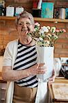 Senior adult woman with floral craftwork