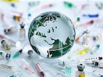 Global Pandemic, Globe of the world surrounded by drugs, vaccines and syringes