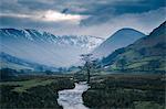 Storm clouds over snow capped mountains at Martindale, The Lake District, UK