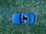 Overhead view of friends in convertible car looking up, Firenze, Toscana, Italy, Europe