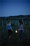 Tourists in vineyard, Tuscany, Italy