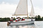 Group of people on sailing boat on lake, Signa, Tuscany, Italy