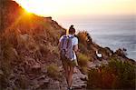 Young woman hiking, rear view, Lions head Mountain, Western Cape, Cape Town, South Africa