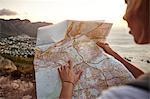 Young woman hiking, looking at map, Lions head Mountain, Western Cape, Cape Town, South Africa