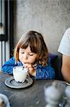 Girl sipping milk in cafe