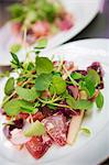 Close up high angle view of plate of food with salad garnish.